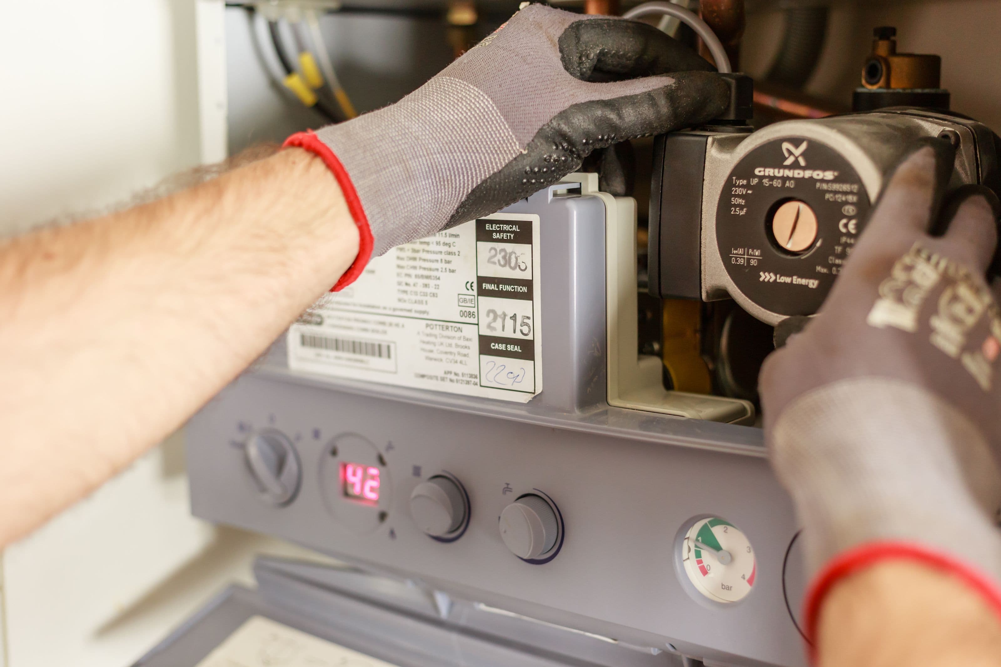 Technician working on the internal components of a domestic gas boiler