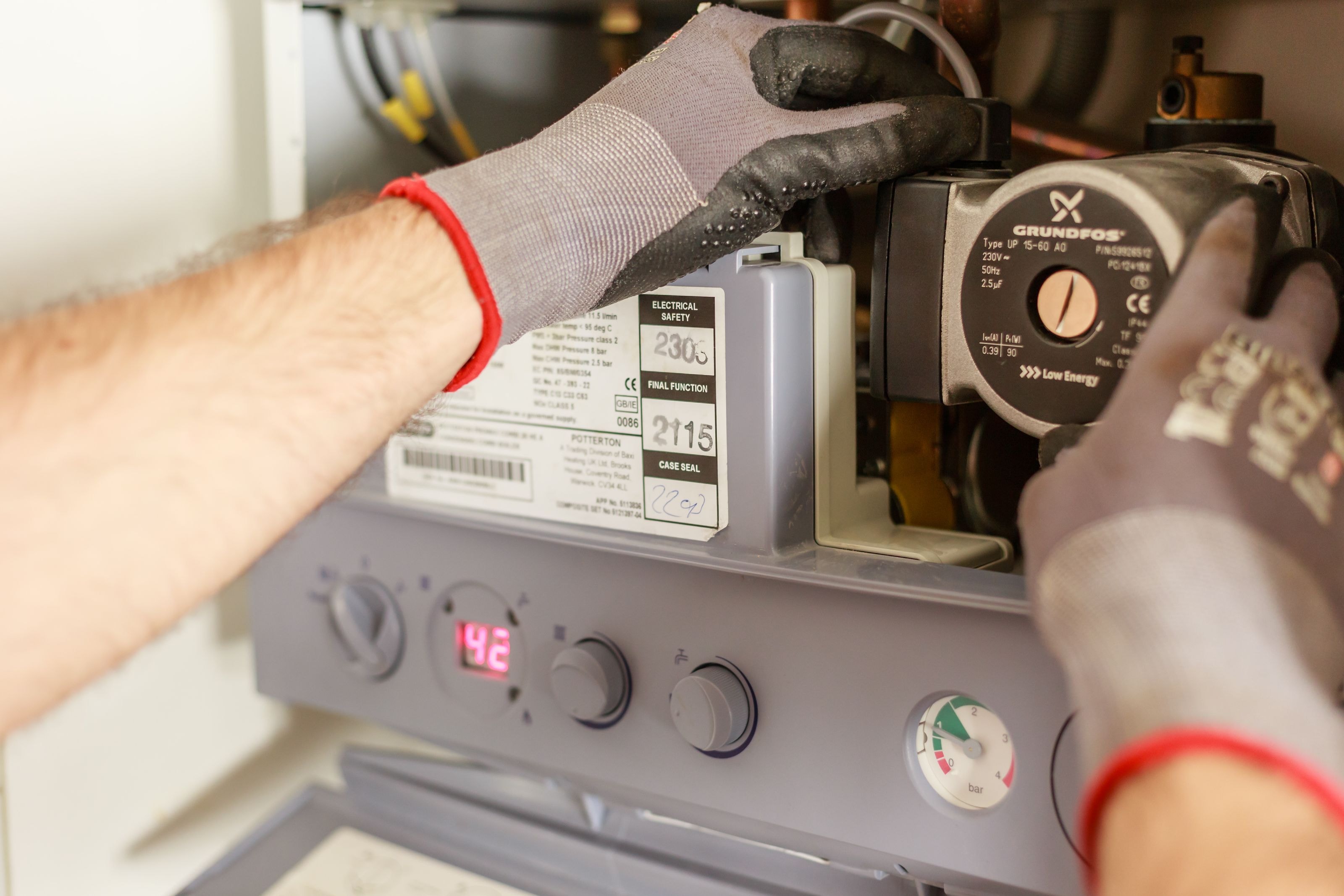 Technician working on the internal components of a domestic gas boiler