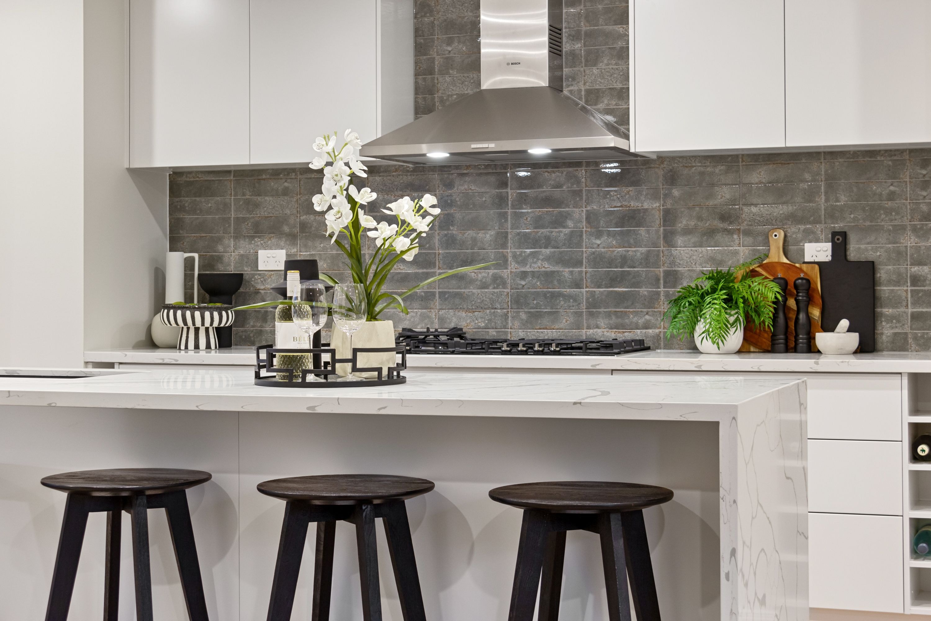 Fitted kitchen with cabinetry, a gas hob and a marble island