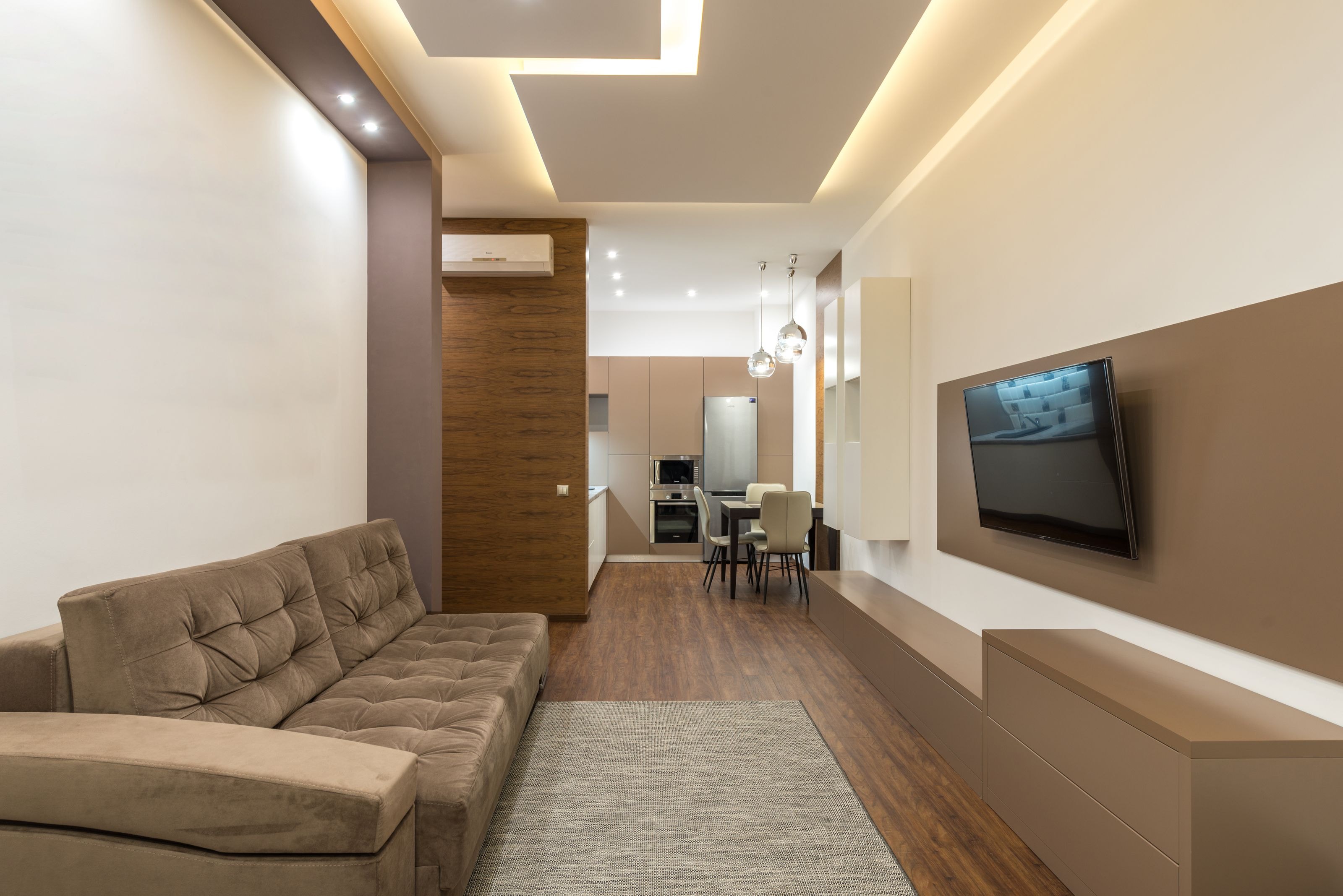 Living-space inspiration with wood flooring and a dining area